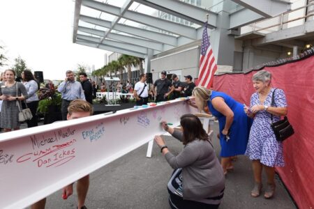people signing a beam
