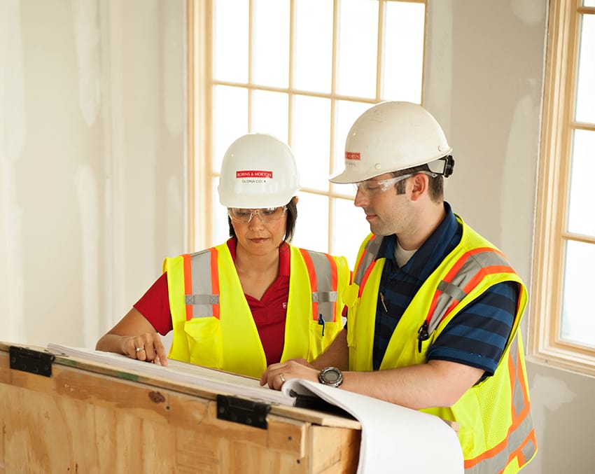man and woman reviewing blueprints together
