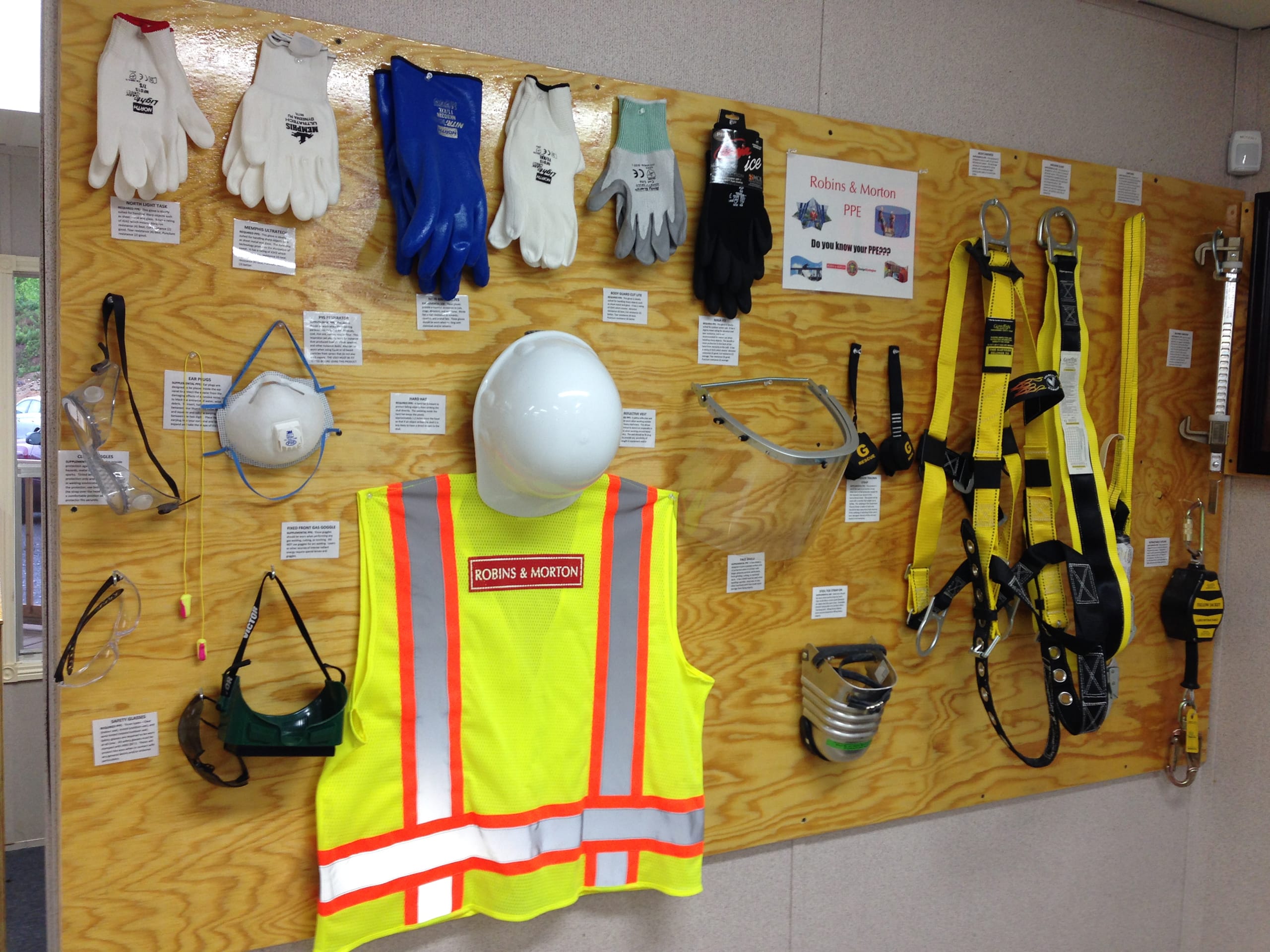 collection of safety equipment posted on a wood panel