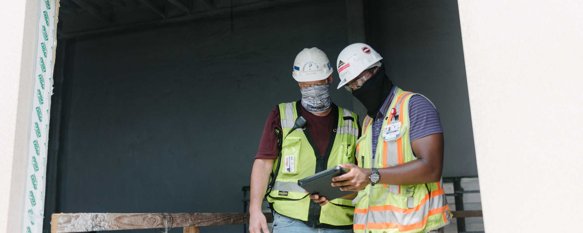 construction workers looking at an ipad